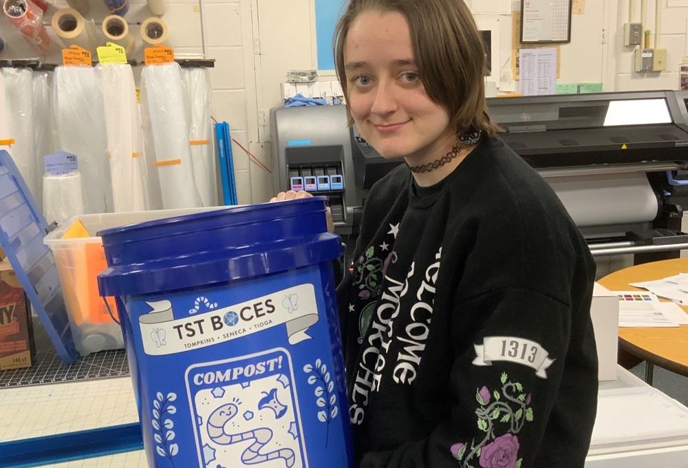 Digital Media student from Dryden CSD Maddison B. personally designed and installed wraps on each compost collection bin, as part of the organization’s collaborative compost pilot program. 
