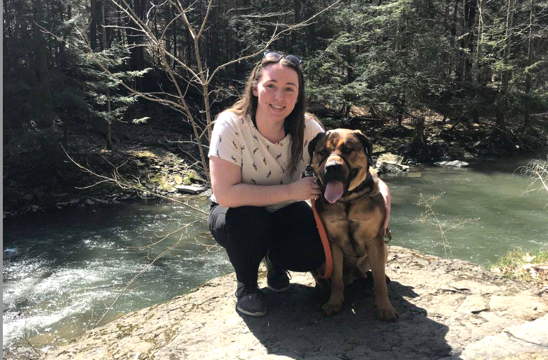 Shelby West and her dog Oso take a break from hiking to smile for the camera.